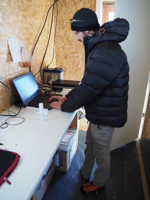 Preben Van Overmeiren looking at data from a probe balloon in a mobile lab